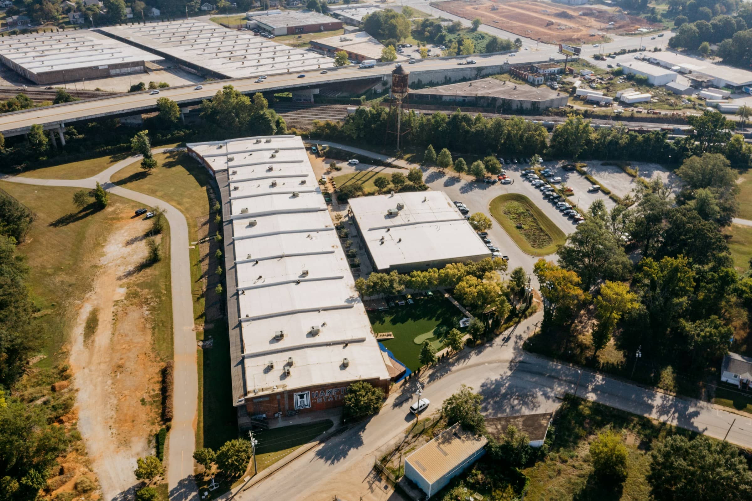 Aerial view of large commercial buildings with white flat membrane roofs